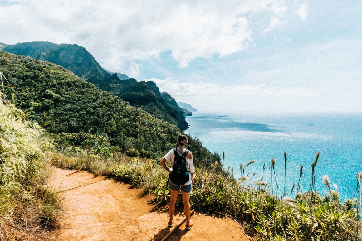 vrouw die uitkijkt op kalalau trail in Hawaii